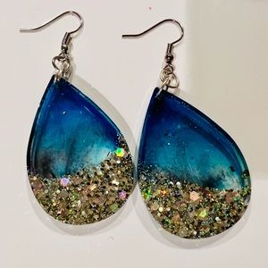 Gorgeous one of a kind blue earrings with silver glittery bottoms. Hand crafted